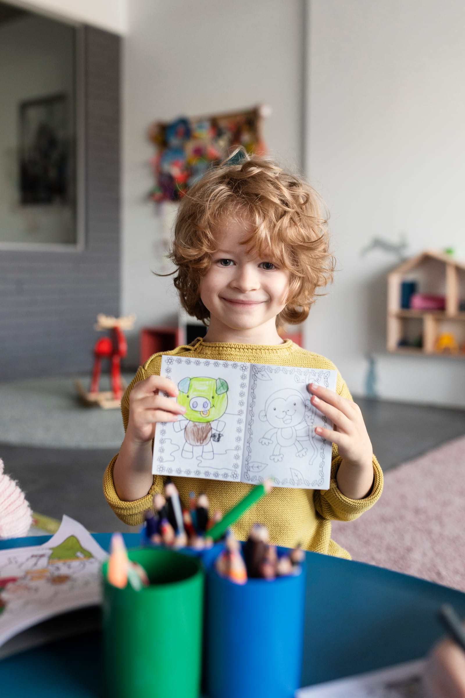 Little Regent child holding a coloring book